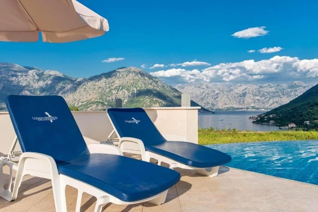 Sun loungers beside the infinity pool with mountain and sea views
