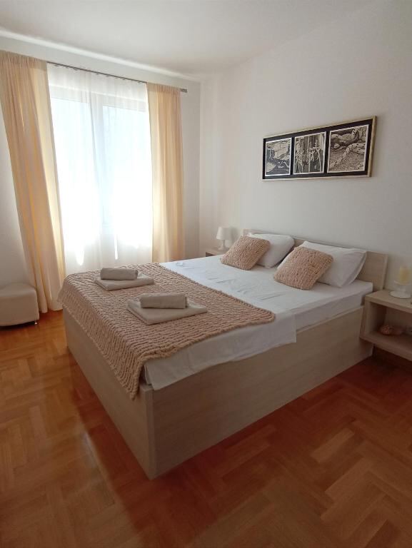 Bedroom with queen bed and balcony window